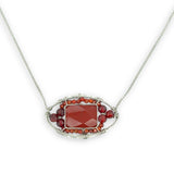 Red jasper tile surrounded by red and orange cubic zirconia gemstones in a hammered sterling silver pendant necklace