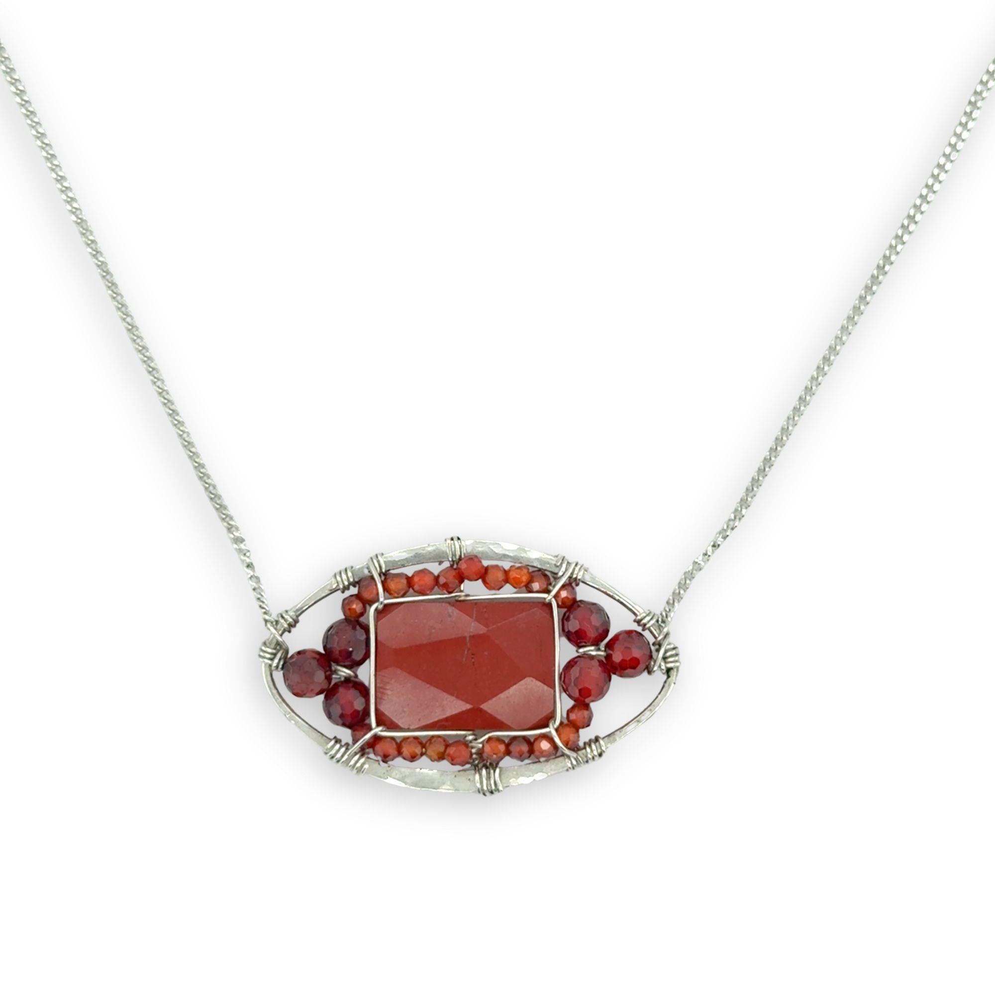 Red jasper tile surrounded by red and orange cubic zirconia gemstones in a hammered sterling silver pendant necklace