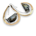 Flashy half moon shaped labradorite gemstones sitting inside a layer of sterling silver wire inside a large hammered brass hook earring with built in earring hooks to wear like a post earring