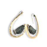 Flashy half moon shaped labradorite gemstones sitting inside a layer of sterling silver wire inside a large hammered brass hook earring with built in earring hooks to wear like a post earring