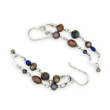 Copper, purple, and indigo blue fresh water pearls, cat's eye and lapis gemstones are suspended between two mini sterling silver hammered arch earrings