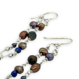 Copper, purple, and indigo blue fresh water pearls, cat's eye and lapis gemstones are suspended between two mini sterling silver hammered arch earrings