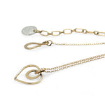 A mini gold-filled heart charm pendant necklace with a hammered texture and an adjustable delicate gold filled chain.