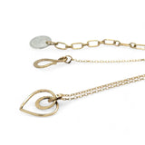 A mini gold-filled heart charm pendant necklace with a hammered texture and an adjustable delicate gold filled chain.