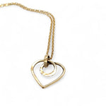 A mini gold-filled heart charm pendant necklace with a hammered texture and an adjustable delicate gold filled chain.