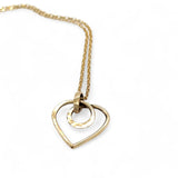 A mini gold-filled heart charm pendant necklace with a hammered texture and an adjustable delicate gold filled chain.