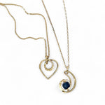 A mini gold-filled heart charm pendant necklace with a hammered texture and an adjustable delicate gold filled chain.