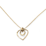 A mini gold-filled heart charm pendant necklace with a hammered texture and an adjustable delicate gold filled chain.