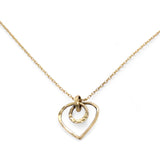 A mini gold-filled heart charm pendant necklace with a hammered texture and an adjustable delicate gold filled chain.