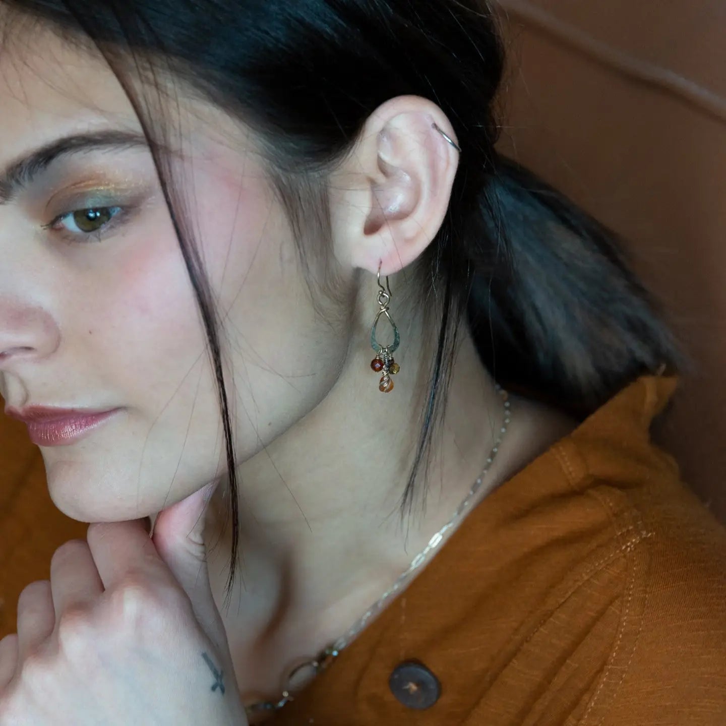 Tiny brass hammered drop earrings with brown crystal, pyrite, and carved hessonite gemstone dangles