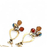 Tiny brass hammered drop earrings with brown crystal, pyrite, and carved hessonite gemstone dangles