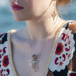 Sterling silver skinny arch earrings with a large hexagonal smokey quartz gemstone with pyrite and brass wire accents.