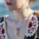 Sterling silver skinny arch earrings with a large hexagonal smokey quartz gemstone with pyrite and brass wire accents.