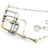 Brass and oxidized stamped sterling silver points to create a mountain scape adorned with fresh water pearl wrapped in gold filled wire on a dainty sterling silver chain necklace