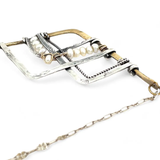 Brass and oxidized stamped sterling silver points to create a mountain scape adorned with fresh water pearl wrapped in gold filled wire on a dainty sterling silver chain necklace