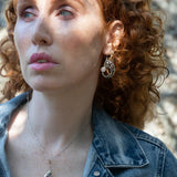 Amethyst, purple fresh water pearl, and pyrite gemstones embellish a sterling silver small earrings with gold filled wire