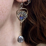 Faceted moonstone drops hang from a mini bronze hot air balloon shaped earring with blue crystal and pyrite gemstones