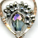 Faceted moonstone drops hang from a mini bronze hot air balloon shaped earring with blue crystal and pyrite gemstones