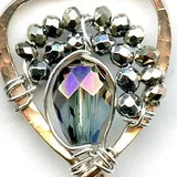 Faceted moonstone drops hang from a mini bronze hot air balloon shaped earring with blue crystal and pyrite gemstones