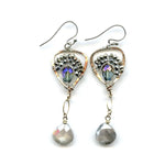 Faceted moonstone drops hang from a mini bronze hot air balloon shaped earring with blue crystal and pyrite gemstones