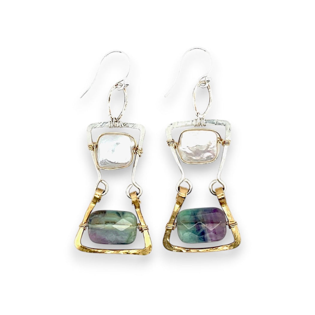 A pair of earrings featuring fluorite gemstones and fresh water pearls in a hourglass shape, with hammered brass and sterling silver details