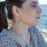 Sterling silver handmade hoop with lavender cubic zirconia stones weaved within brass and oxidized sterling silver twisted wire