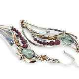 Crystal, garnet, and pyrite gemstones decorate sterling silver wing earrings with bronze accents
