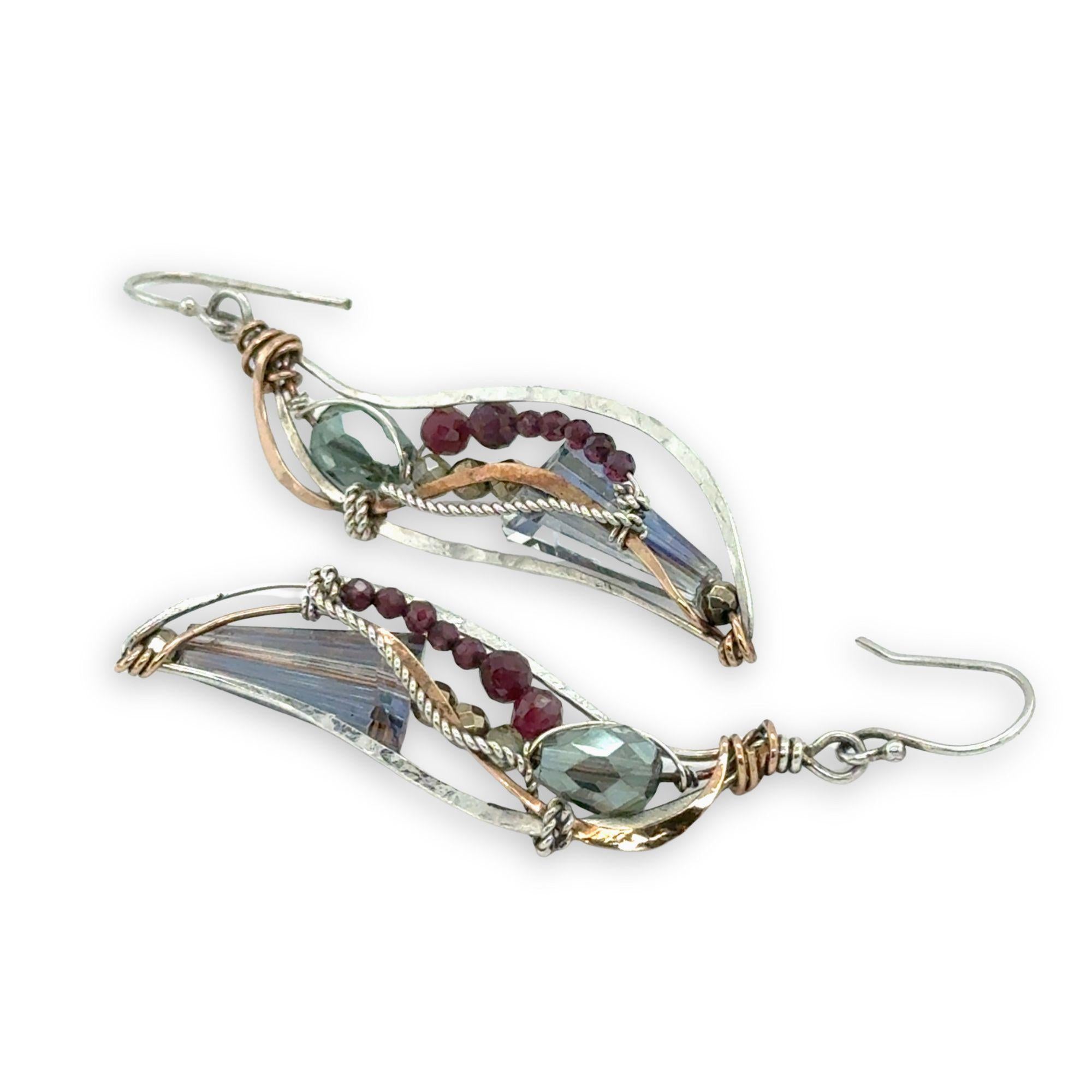 Crystal, garnet, and pyrite gemstones decorate sterling silver wing earrings with bronze accents