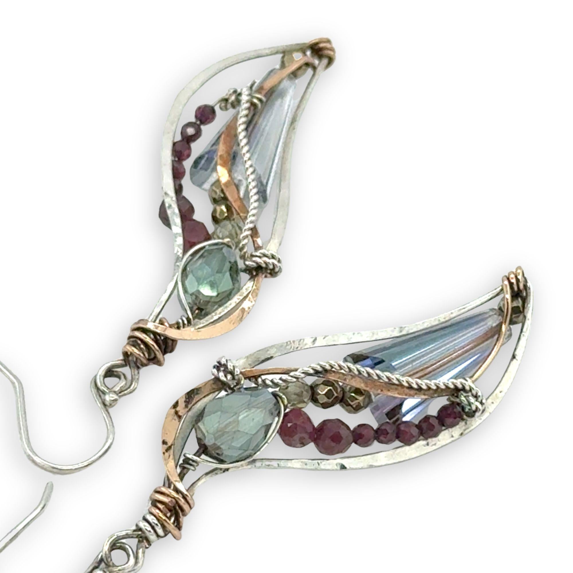 Crystal, garnet, and pyrite gemstones decorate sterling silver wing earrings with bronze accents