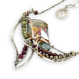 Garnet, green cubic zirconia, pyrite, and colorful crystal gemstones in oxidized stamped sterling silver wing necklace pendant with bronze accents