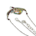 Garnet, green cubic zirconia, pyrite, and colorful crystal gemstones in oxidized stamped sterling silver wing necklace pendant with bronze accents