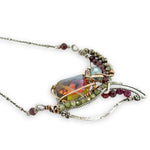Garnet, green cubic zirconia, pyrite, and colorful crystal gemstones in oxidized stamped sterling silver wing necklace pendant with bronze accents