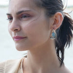 oxidized sterling silver semi circle earrings featuring smooth larimar ovals and apatite gemstones with built in earring hooks that wear like a post earring