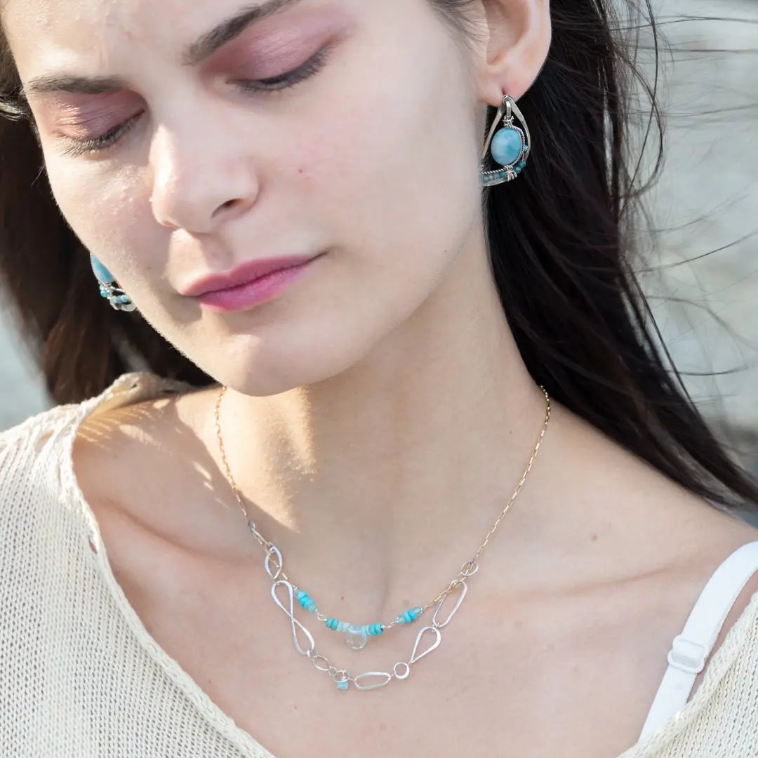 oxidized sterling silver semi circle earrings featuring smooth larimar ovals and apatite gemstones with built in earring hooks that wear like a post earring