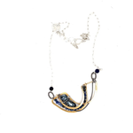 Brass statement necklace with pyrite and moonstone drops, accompanied by sodalite and pyrite gemstones laced on with sterling silver wire, accented with dark braided links within a sterling silver chain