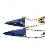 Faceted lapis triangles hang from oxidized and gold dot chain hanging from brass mini diamonds lined with pyrite earrings