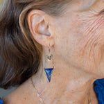 Faceted lapis triangles hang from oxidized and gold dot chain hanging from brass mini diamonds lined with pyrite earrings