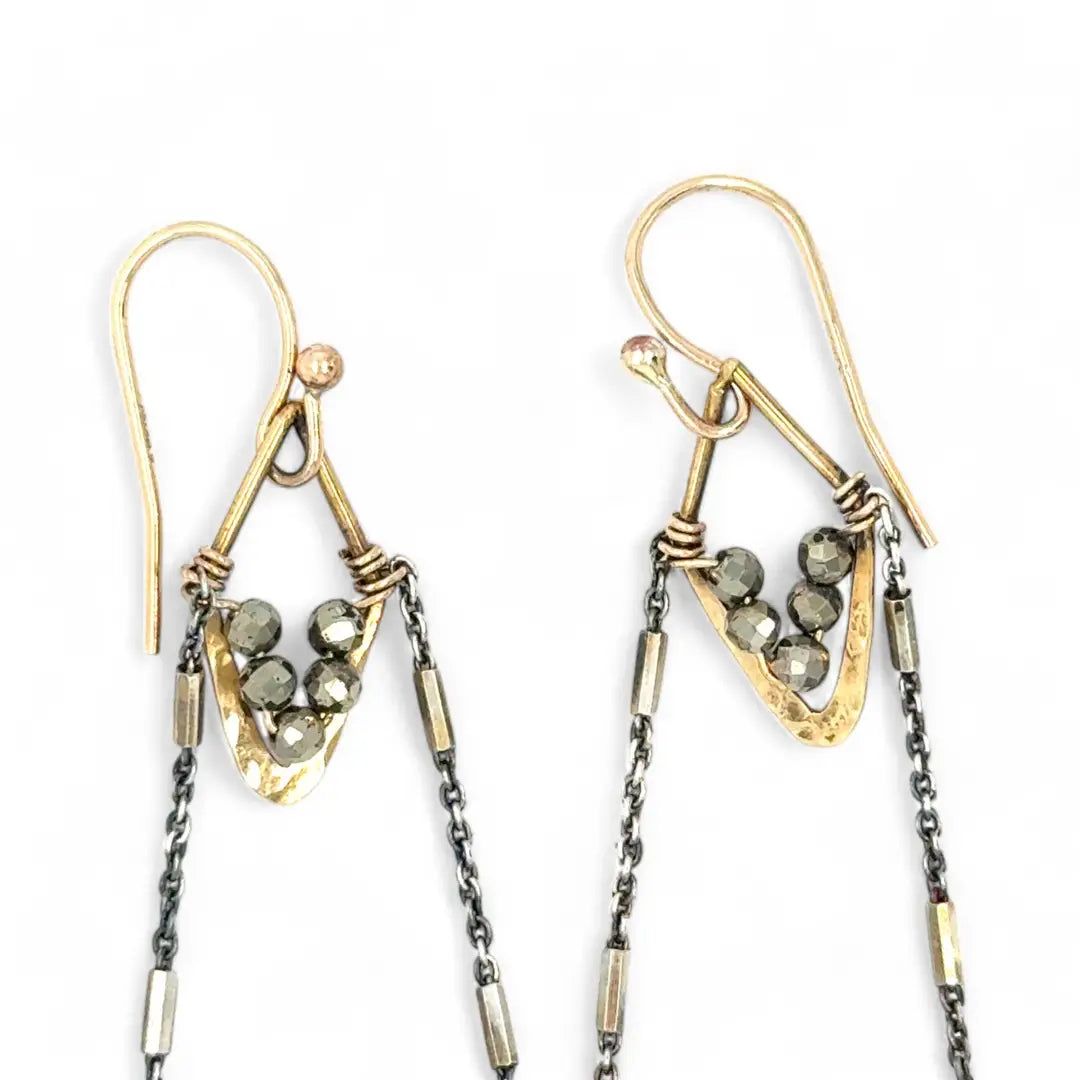 Faceted lapis triangles hang from oxidized and gold dot chain hanging from brass mini diamonds lined with pyrite earrings