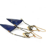 Faceted lapis triangles hang from oxidized and gold dot chain hanging from brass mini diamonds lined with pyrite earrings