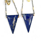 Faceted lapis triangles hang from oxidized and gold dot chain hanging from brass mini diamonds lined with pyrite earrings