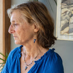Faceted lapis triangles hang from oxidized and gold dot chain hanging from brass mini diamonds lined with pyrite earrings