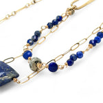 Handmade brass oval links suspended between pyrite gemstones links and lapis gemstones with a lapis point on gold filled oval chain layered necklace