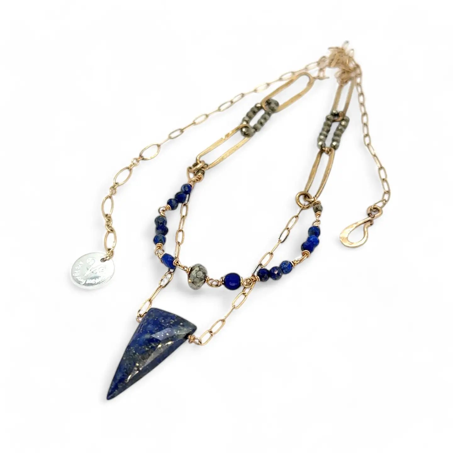 Handmade brass oval links suspended between pyrite gemstones links and lapis gemstones with a lapis point on gold filled oval chain layered necklace