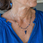 Handmade brass oval links suspended between pyrite gemstones links and lapis gemstones with a lapis point on gold filled oval chain layered necklace