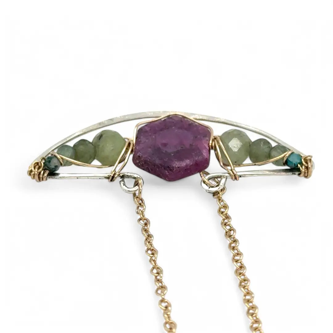 Pink tourmaline hexagon slice surrounded by green kyanite gemstones inside a hammered sterling silver boat shaped pendant, wrapped in gold fill wire with gold filled delicate chain necklace