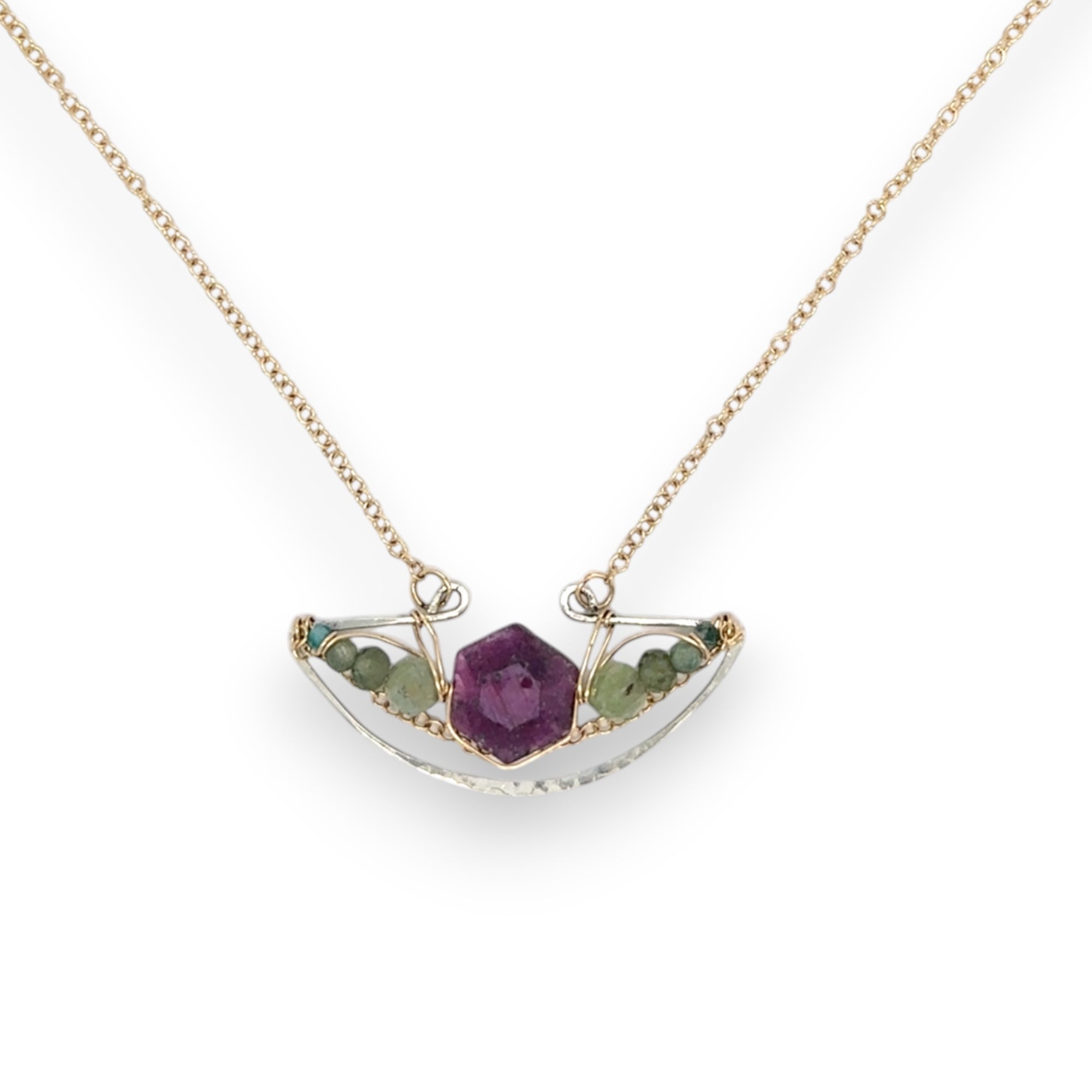Pink tourmaline hexagon slice surrounded by green kyanite gemstones inside a hammered sterling silver boat shaped pendant, wrapped in gold fill wire with gold filled delicate chain necklace