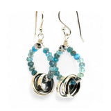 Faceted apatite gemstones form a ring that holds onto and oxidized sterling silver hand formed knot earring