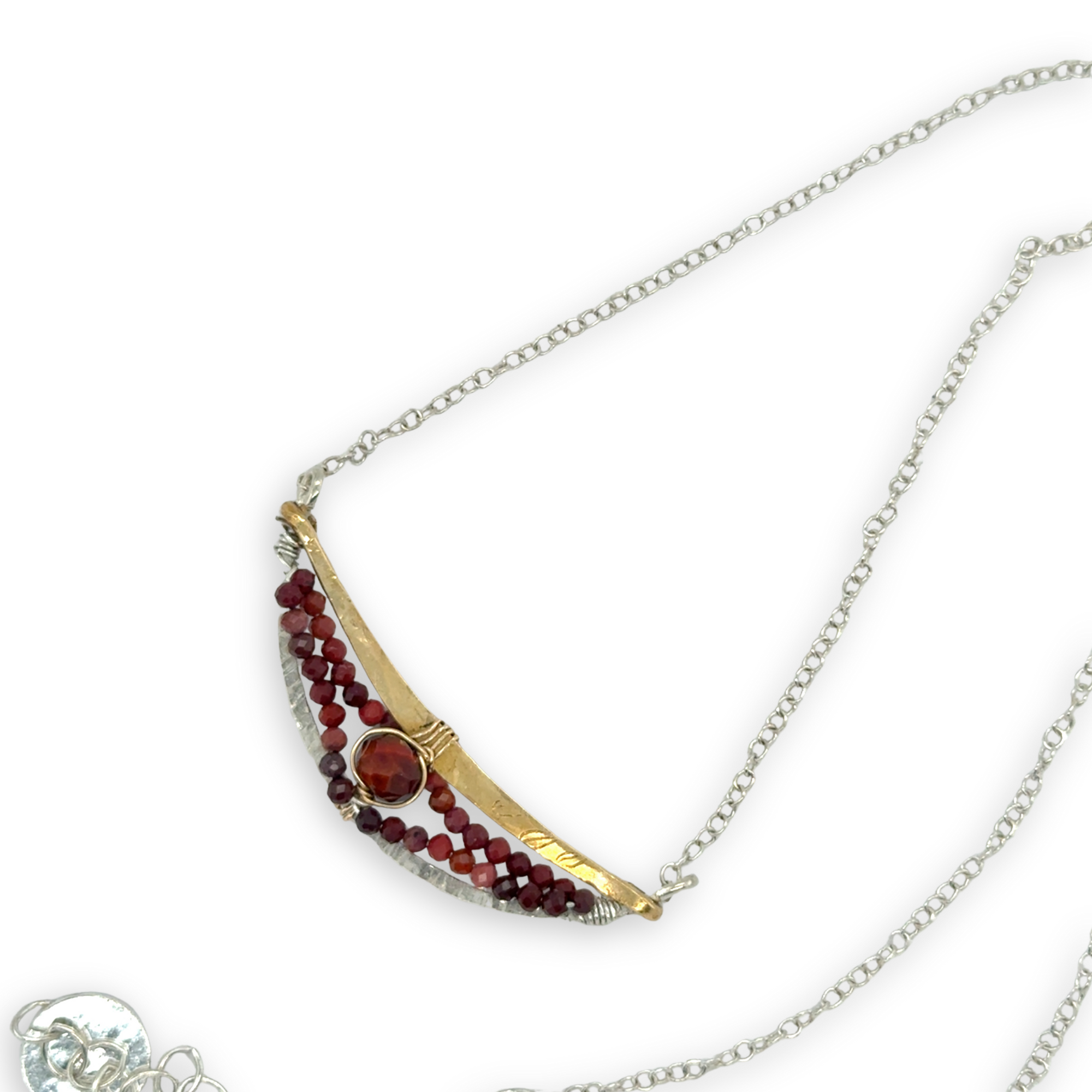 Hammered sterling silver and brass crescent necklace filled with red tiger's eye and mookaite jasper gemstones on a delicate sterling chain