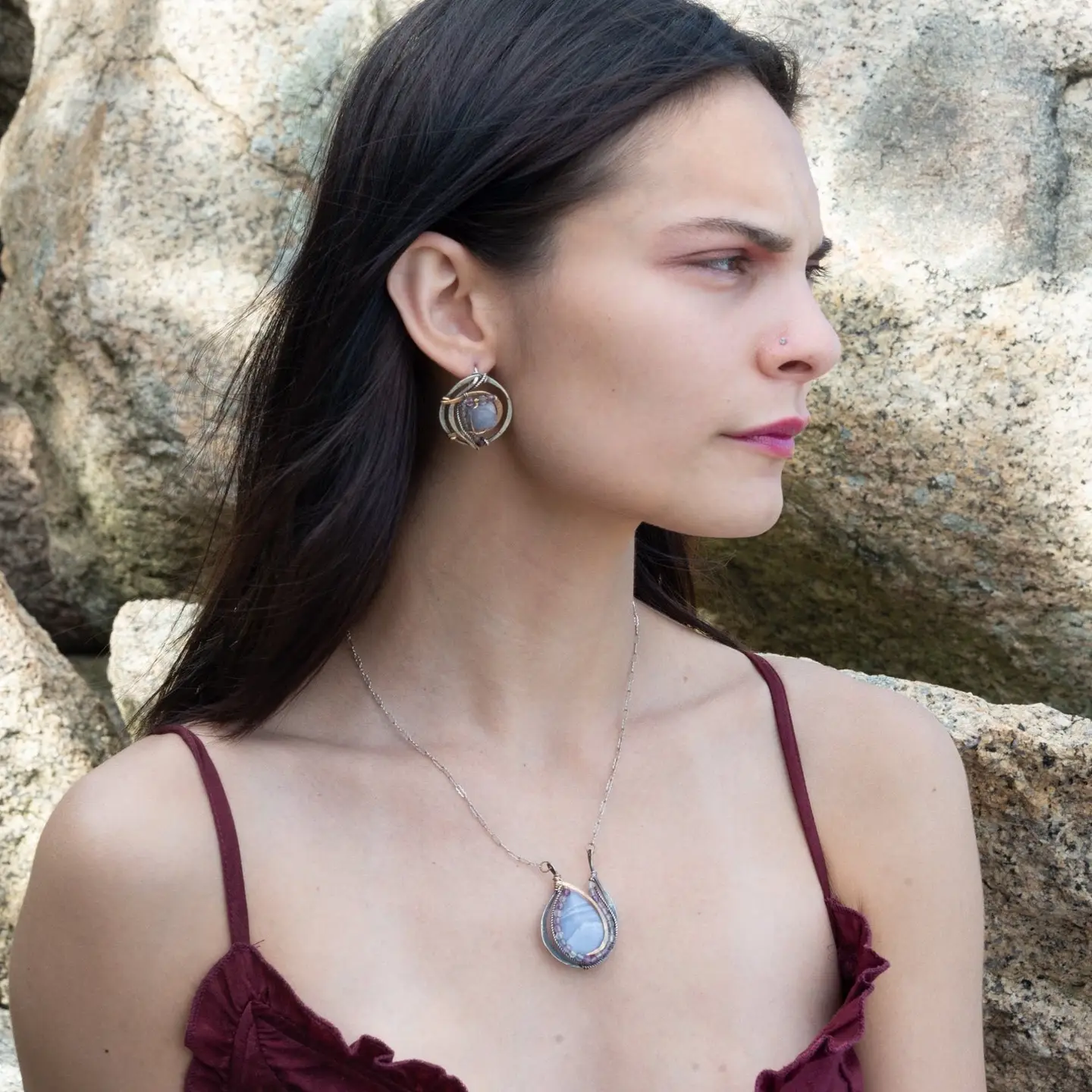 oxidized sterling silver hoops with stamped bronze and oxidized sterling twist swishes holding an iolite faceted tile and fluorite gemstones with built in earring hooks that wear like a post earrings