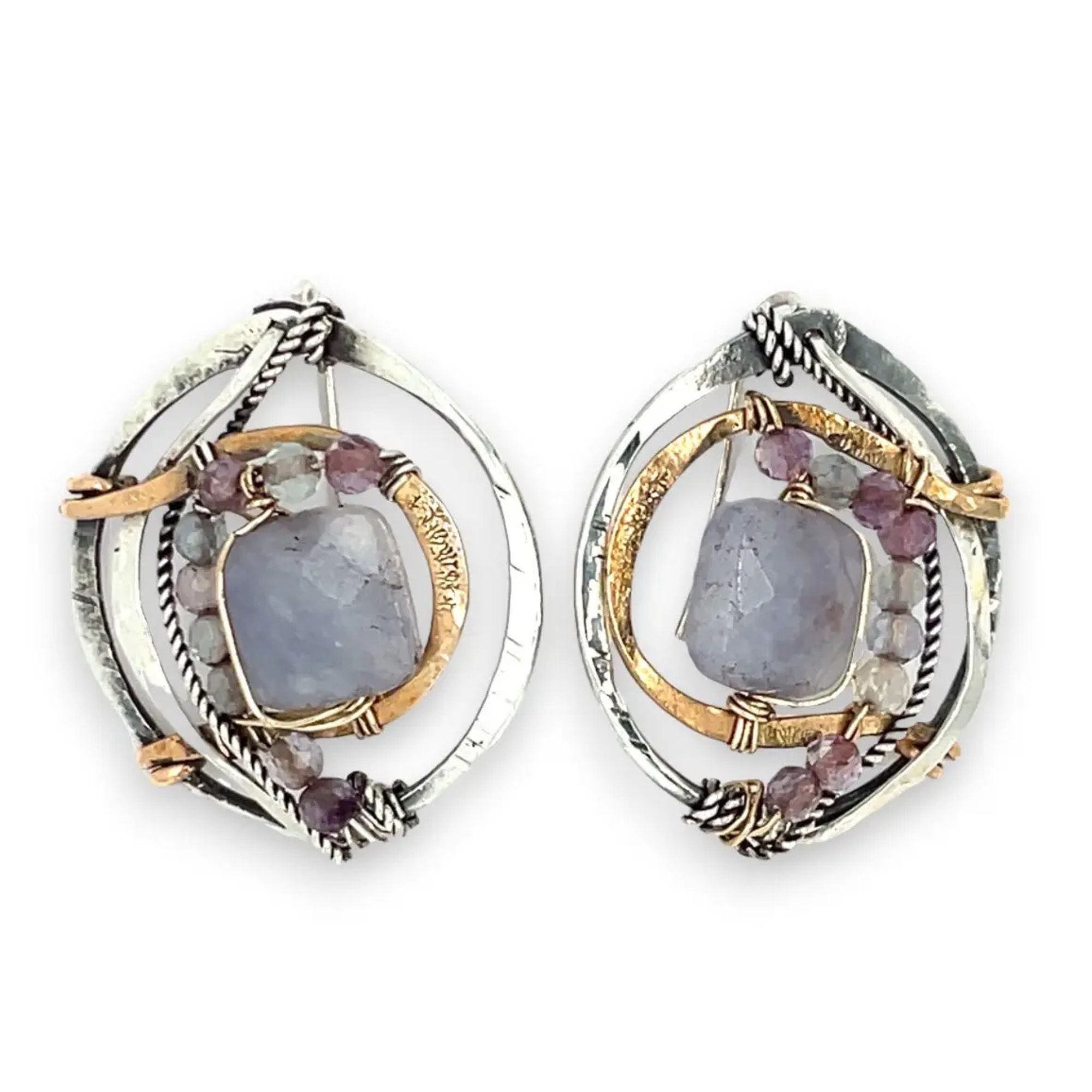 oxidized sterling silver hoops with stamped bronze and oxidized sterling twist swishes holding an iolite faceted tile and fluorite gemstones with built in earring hooks that wear like a post earrings